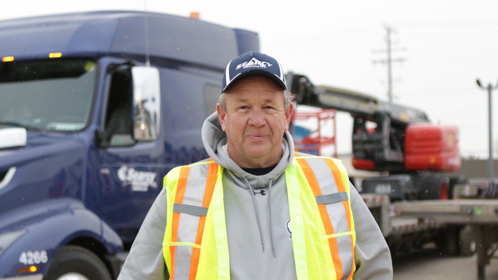 Searcy Trucking employee in front of a Searcy truck